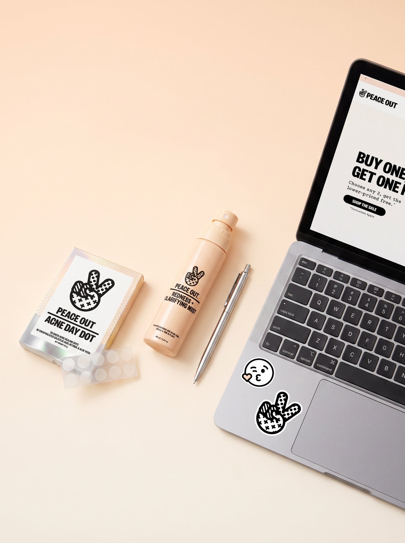 Acne Day Dot box and Redness Clarifying Mist beside a laptop showing a Peace Out sale page