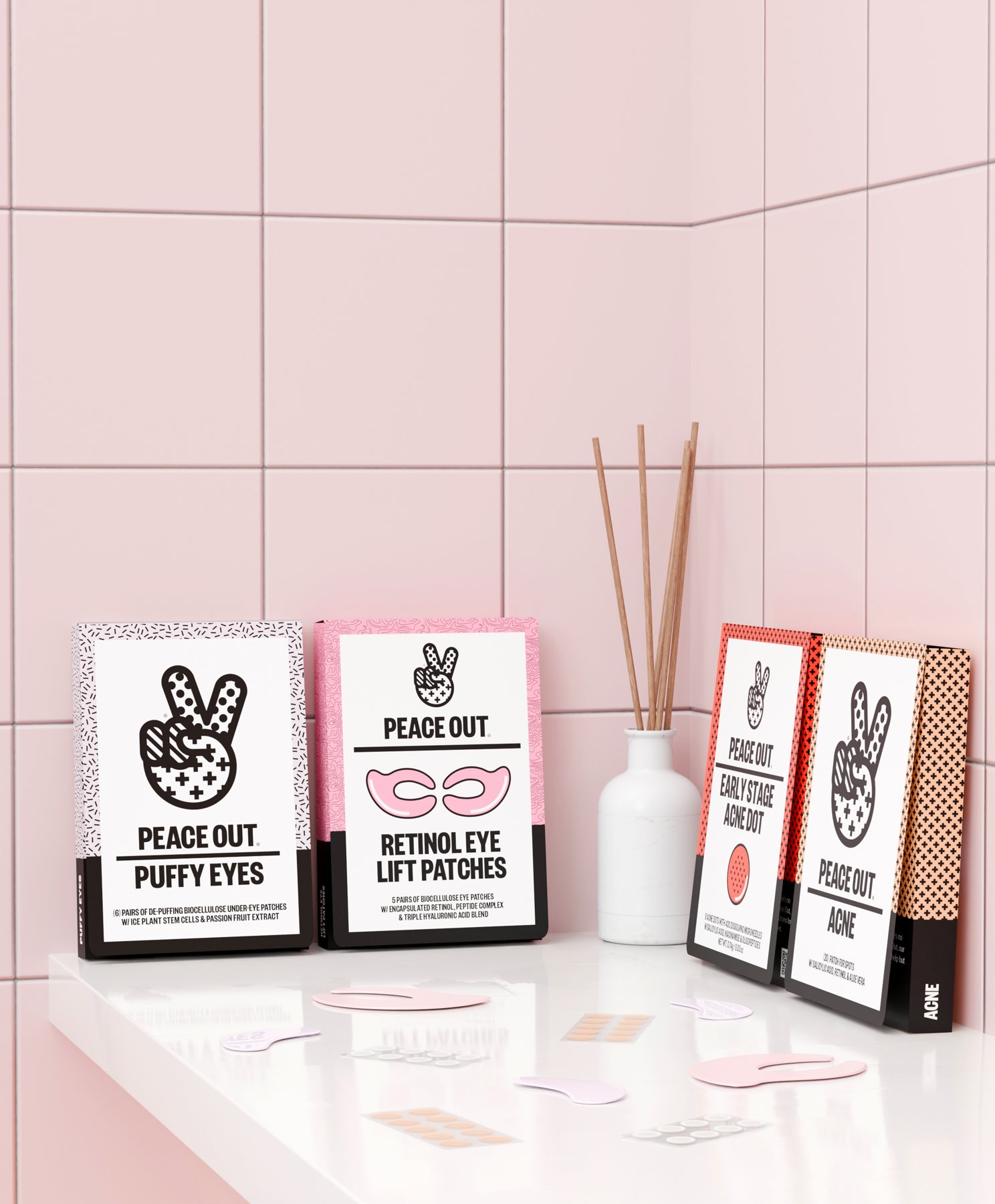 Puffy Eyes, Retinol Eye Lift, Early Stage Acne Dot and Acne boxes on a white shelf against pink tile